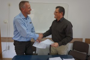 Signing Partnership agreement.  Rev Norm Poehlke and Rev Joseph Siimon